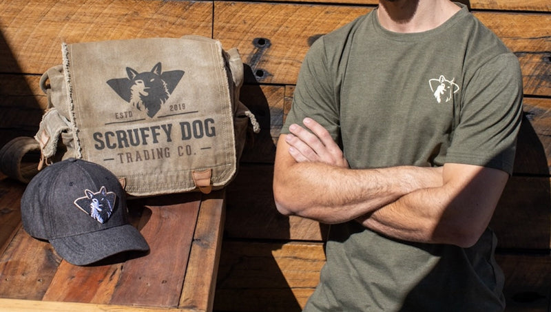 Vintage messenger bag, denim cotton cap and bandana on a wooden table