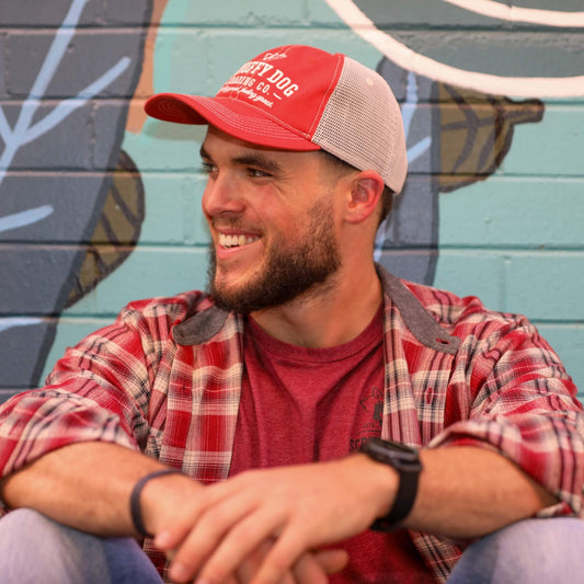 Unisex vintage red trucker hat worn outdoors by Scruffy Dog